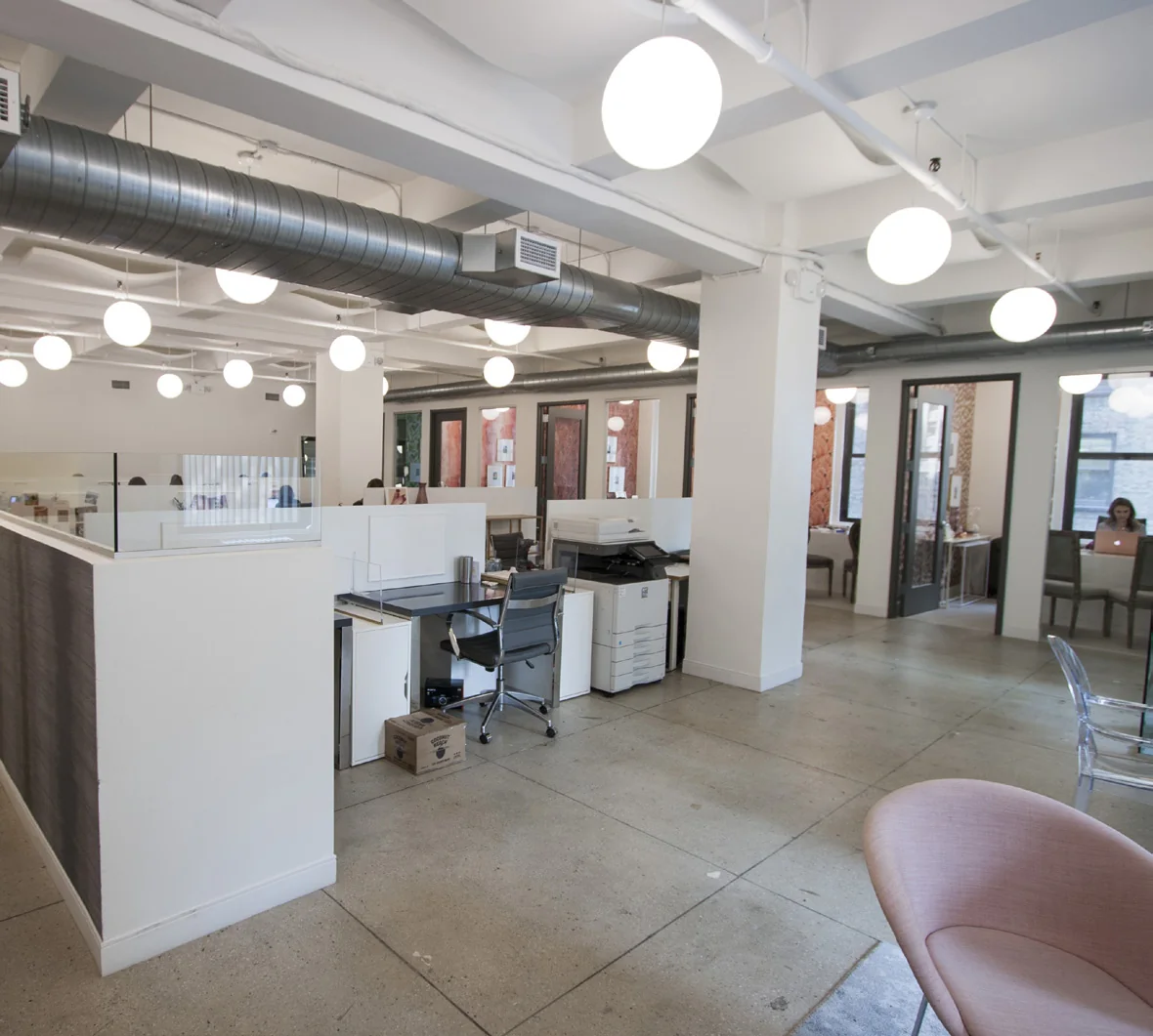 Fashion showroom floor with work tables and garment racks
